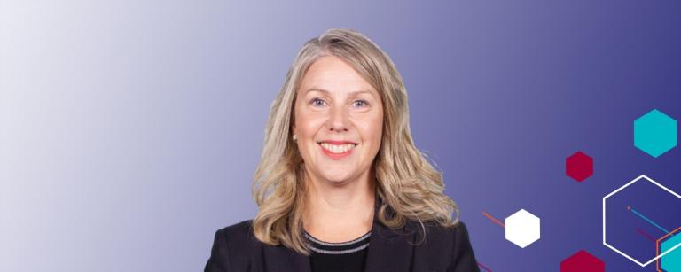 An image of Deborah Jenkins smiling on a purple to white gradient background with abstract hexagons on the right hand side