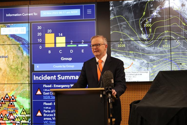 A photograph of Prime Minister the Hon Anthony Albanese MP opening the new National Situation Room. He is standing at a podium in front of images of Australian weather incidents and patterns.
