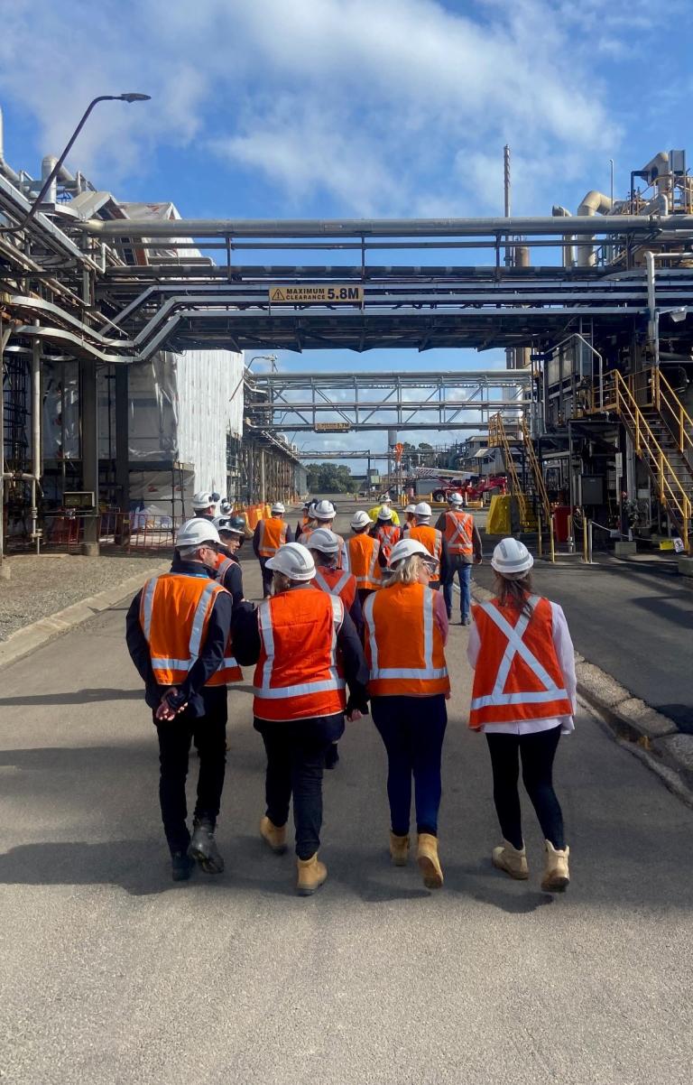 A photograph of a group of staff from the Net Zero Economy Agency visiting an ammonium nitrate site at Kooragang Island in NSW.