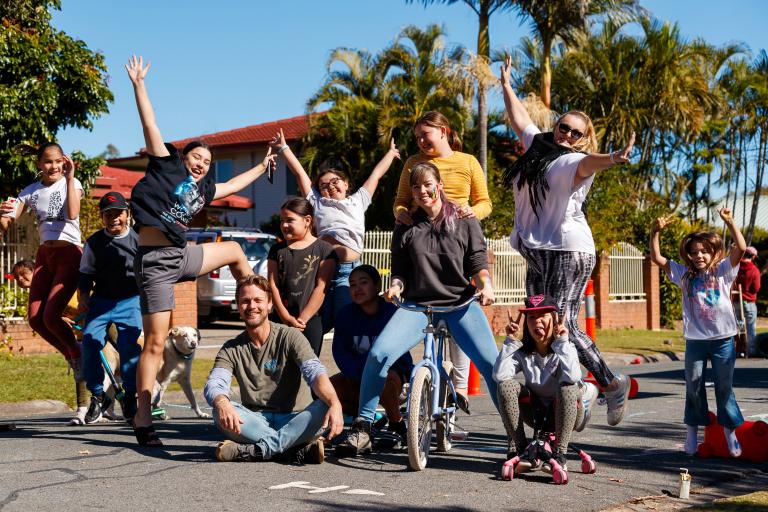 A photograph of a group of people from the Logan Together movement, on a suburban street.