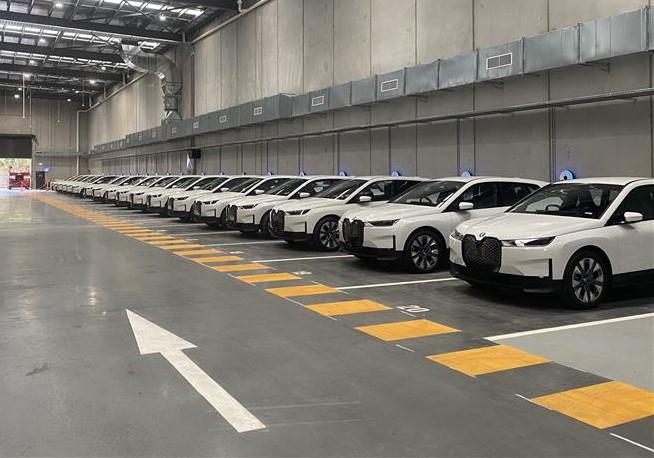 A photograph of COMCAR’s electric vehicle fleet and charging facility located in Melbourne.