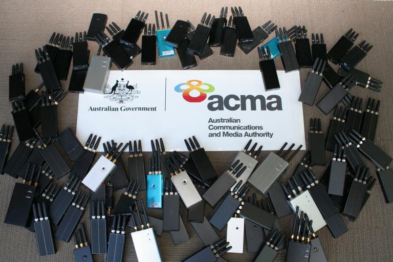 A photograph of banned wi-fi and mobile jammers, next to the logo of the Australian Communications and Media Authority.