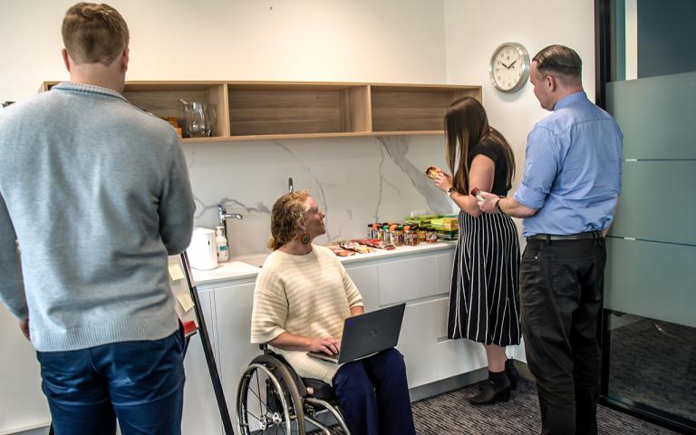 A photograph of 4 staff members from Food Standards Australia and New Zealand inspecting jars of herbs and spices. 