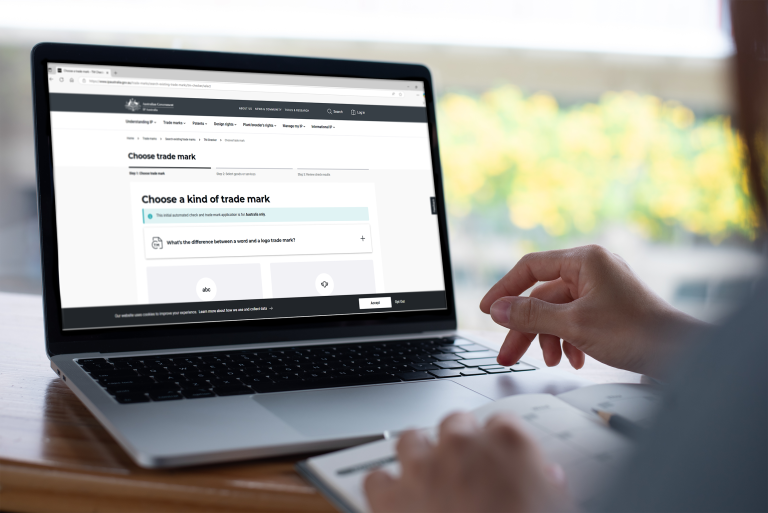 A photograph of a laptop screen showing the Trade Mark Checker on IP Australia’s website. 