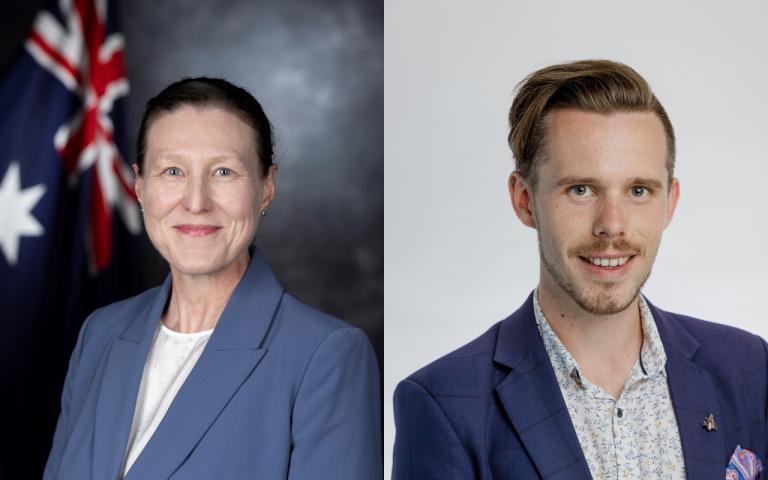 A photo showing 2 people. Jennifer is on the left and is wearing a blue blazer jacket and a white blouse, there is an Australian flag in the background. Ben is on the right, he is wearing a blue blazer with a patterned shirt underneath.