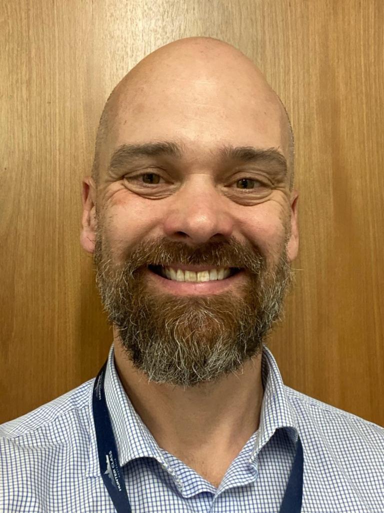 A head shot photograph of Brett Fenton, a member of the Complex Project Management Profession. 