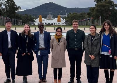 7 graduates from the APSC graduate intake stand outside Parliament House