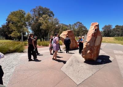 A group of graduates enjoying Canberra's sunny weather outside while on tour of local landmarks