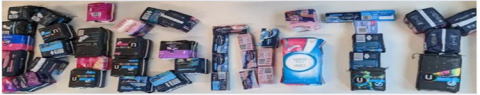 a selection of menstrual products arranged to spell the word dignity