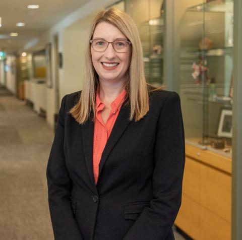 A photograph of Alison Stott, a woman smiling wearing a black blazer.