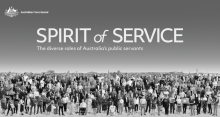 A black and white photo of a group of public servants taken outdoors. Across the top of the photo the words "Spirit of Service" can be seen, as well as an Australian government crest