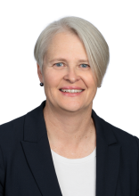 Headshot of Jo Talbot, a smiling woman in a black blazer