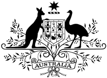 The official Commonwealth Coat of Arms featuring a central shield divided into six parts, supported by a kangaroo and an emu. A seven-pointed gold Commonwealth Star sits above the shield, framed by golden wattle with Australia written on a banner.