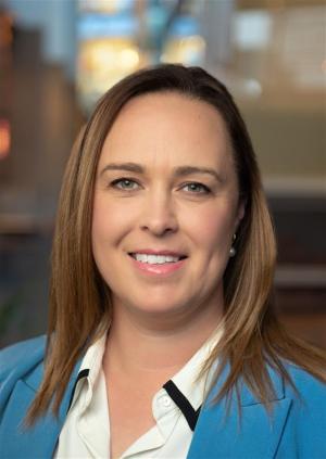 Close up image of Karmin Van Grossen, smiling, with a blue jacket on. 
